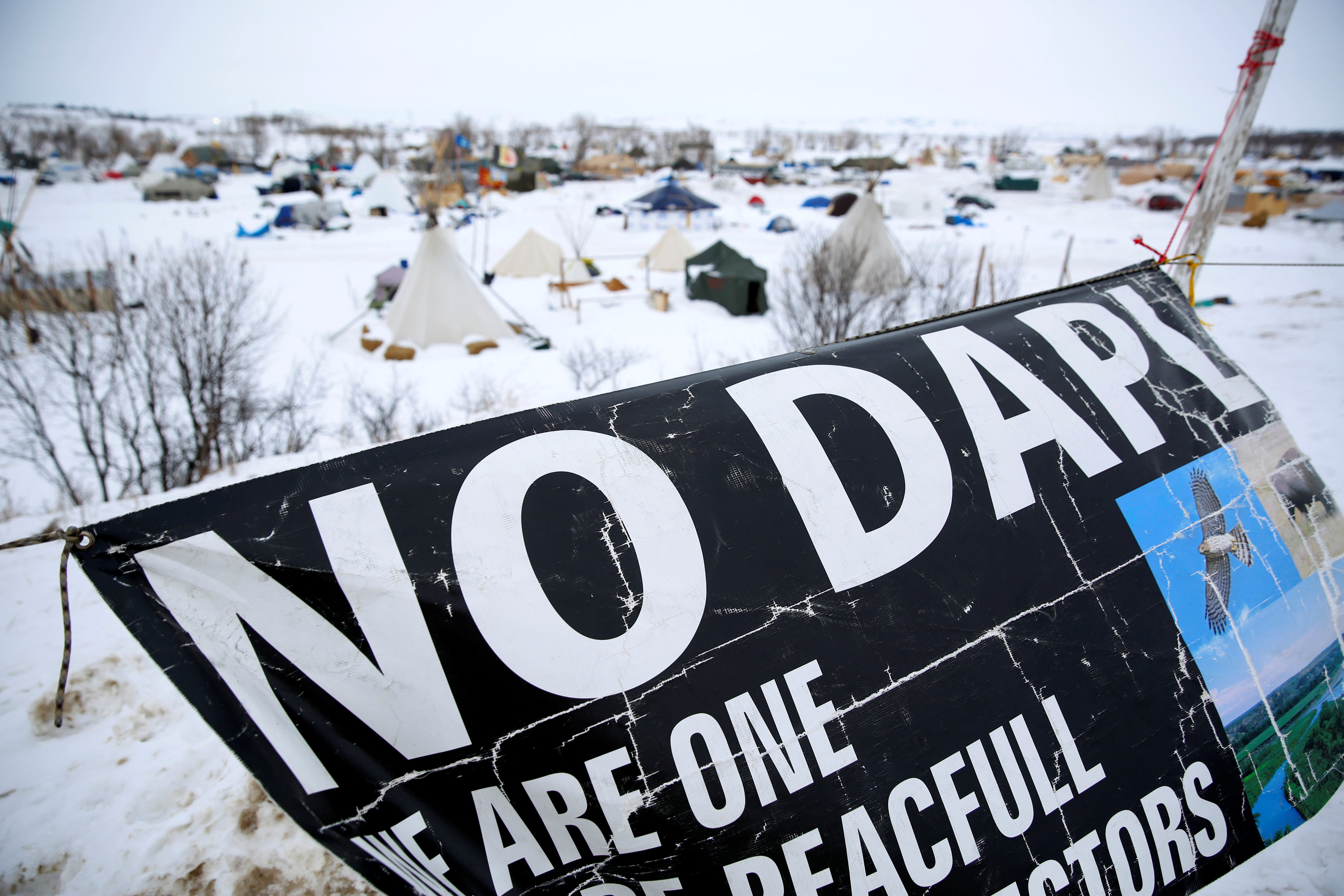A banner flaps in the wind at the Dakota Access Pipeline protest camp near Cannon Ball, North Dakota, on Jan. 24. | REUTERS
