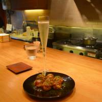 High and low: <em>Takoyaki</em> and champagne go well together. | J.J. O’DONOGHUE