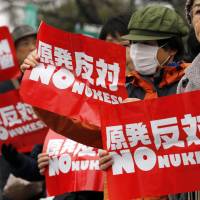 Anti-nuclear protesters hold placards in front of the Diet building in Tokyo last year. The majority of Japanese people remain opposed to restarting the nation’s nuclear reactors in the wake of the Fukushima nuclear disaster. Only 5 percent of Japanese surveyed in a poll last year said they would like to see Japan become a nuclear weapons power. Does the nuclear option make sense for Japan?