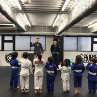 Hands up for jiujitsu: The young students of a Carpe Diem Brazilian jiujitsu class get ready for some action. Let kids seize the day, and an opponent