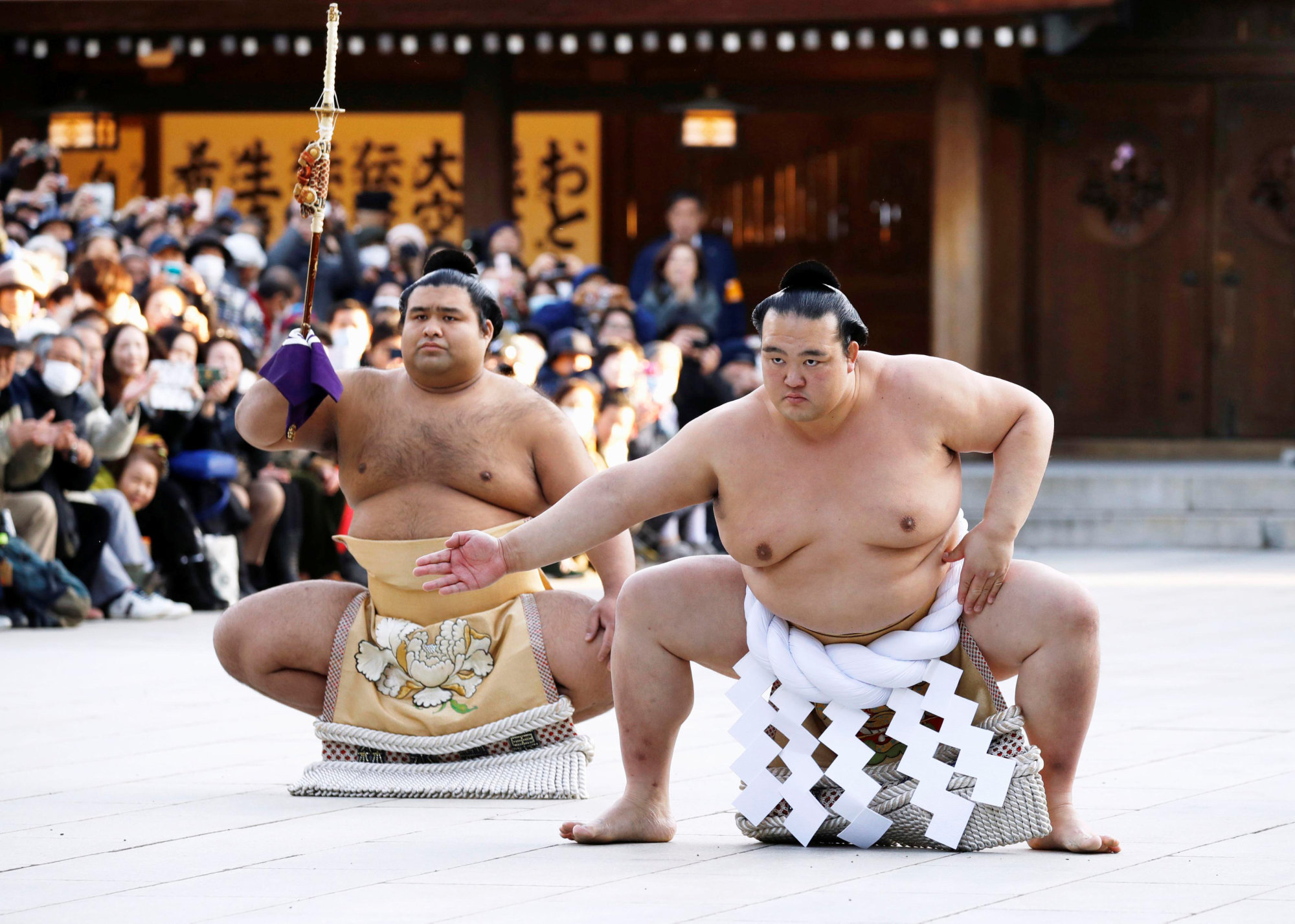 Newly promoted sumo grand champion Kisenosato, wearing a ceremonial belly band, performs a sacred ring-entering ritual at Meiji Shrine in Tokyo on Jan. 27. | KYODO VIA REUTERS