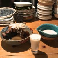 Doburoku sake with simmered yellowtail and daikon. | ROBBIE SWINNERTON