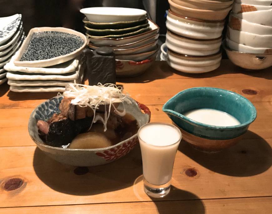 Hotaru Doburoku sake with simmered yellowtail and daikon. | ROBBIE SWINNERTON
