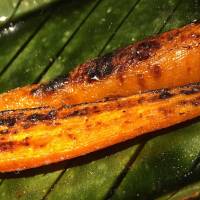 Fresh vegetables, such as this perfectly charcoal-grilled carrot, get their own dedicated grill.  | ROBBIE SWINNERTON
