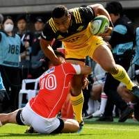 The Hurricanes’ Ngani Laumape attempts to get past the Sunwolves’ Hikaru Tamura on Saturday. Sunwolves crushed in Super Rugby opener