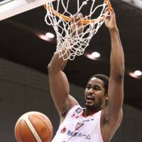 Jets center Hilton Armstrong completes a slam dunk against the B-Corsairs on Saturday night at Yokohama International Swimming Pool. Yokohama defeated Chiba 72-70. | KAZ NAGATSUKA
