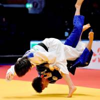 Uta Abe (left) throws Amandine Buchard for a wazari in the women\'s 52-kg final on Friday in Dusseldorf, Germany. The 16-year-old Abe became the youngest judoka in history to win a Grand Prix title. | KYODO