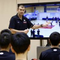 Interim Japan men\'s national team head coach Luka Pavicevic reviews film with his players during a training camp at Tokyo\'s National Training Center last week. | KAZ NAGATSUKA