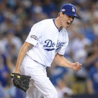 Journeyman hurler Rich Hill, seen celebrating on the mound during an NLCS game last season, has re-signed with the Los Angeles Dodgers for &#36;48 million over three years. | USA TODAY / VIA REUTERS