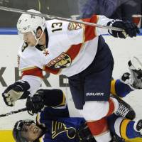 The Panthers’ Mark Pysyk (top) checks the Blues’ David Perron in the third period on Monday. Florida defeated St. Louis 2-1. Panthers edge Blues, complete 5-0 road trip