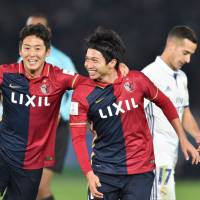 Gaku Shibasaki (right) celebrates with Kashima teammate Ryota Nagaki after scoring against Real Madrid in the Club World Cup final in December. | AFP-JIJI