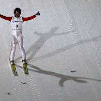 Naoki Nakamura celebrates after his second-round jump during the ski jumping men\'s large hill individual event at the Asian Winter Games in Sapporo on Friday. | AP