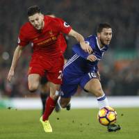 Liverpool\'s Adam Lallana (left) and Chelsea\'s Eden Hazard compete for the ball during their 1-1 draw at Stamford Bridge on Tuesday. | REUTERS