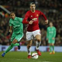 Manchester United\'s Zlatan Ibrahimovic moves the ball as St. Etienne\'s Kevin Monnet-Paquet looks on in Europa League action on Thursday. Man United won 3-0. | REUTERS