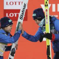 Runner-up Sara Takanashi (left) congratulates winner Yuki Ito after a World Cup ski jumping event in Pyeongchang, South Korea, on Wednesday. | AP