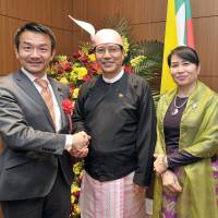 Myanmar\'s Ambassador Thurain Thant Zin (center) and his wife Khin Soe Naung welcome Parliamentary Vice-Minister for Foreign Affairs Kiyoshi Odawara to a reception celebrating the 69th Independence Day Anniversary of the Republic of the Union of Myanmar at the embassy on Jan. 30. | YOSHIAKI MIURA
