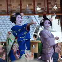 Apprentice geisha known as maiko throw beans Friday at Yasaka Shrine in the city of Kyoto to celebrate Setsubun, the day before spring. The maiko yelled \"Fuku wa uchi!\" (\"Fortune in!\") as they threw the beans to pray for happiness and health throughout the year. | SATOKO KAWASAKI