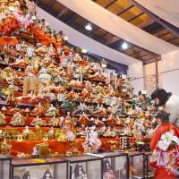Traditional hina dolls are displayed on an 8-meter stepped pyramid at a festival involving some 30,000 of the dolls that began Sunday in Katsuura, Tokushima Prefecture. The dolls were all donated by people whose daughters are now grown-ups. | KYODO