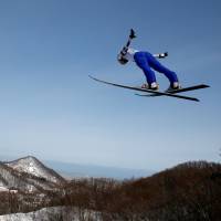 Yukiya Sato competes in the normal hill ski jumping competition during the Asian Winter Games on Wednesday at Sapporo\'s Miyanomori Ski Jump Stadium. Sato won the gold medal with Yuken Iwasa earning silver. | REUTERS