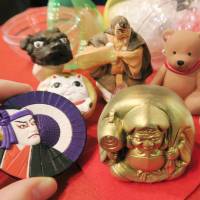 Miniature traditional dolls and trinkets that will go on sale at an event being held at the Hakata Traditional Craft and Design Museum in Fukuoka Prefecture are put on display Wednesday. The clay-fired pieces, which will be sold through vending machines, can be purchased for 500 yen from Thursday. | KYODO
