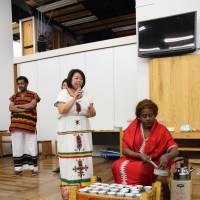 Haile Mahelet Alemayehu from the Ethiopian embassy in Tokyo prepares coffee in a coffee ceremony while Ethiopian Art Club of Japan representative Junko Yamamoto explains the procedure during a seminar at the Minato City Eco-Plaza on March 8. | MASAAKI KAMEDA