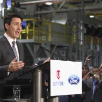 Canadian Prime Minister Justin Trudeau speaks at the Ford Essex Engine Plant in Windsor, Ontario, on Thursday. Ford Motor Co. is hiring more than 300 engineers for a new connected-vehicle research center in Ottawa, the automaker said Thursday. Ford taps 400 BlackBerry workers for Canada connected-vehicle research