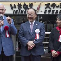 Ikinari Steak founder Kunio Ichinose listens as former New York Mets manager and player Bobby Valentine speaks during a ceremony marking the chain\'s opening in the United States on Feb. 23 in New York City. | AP