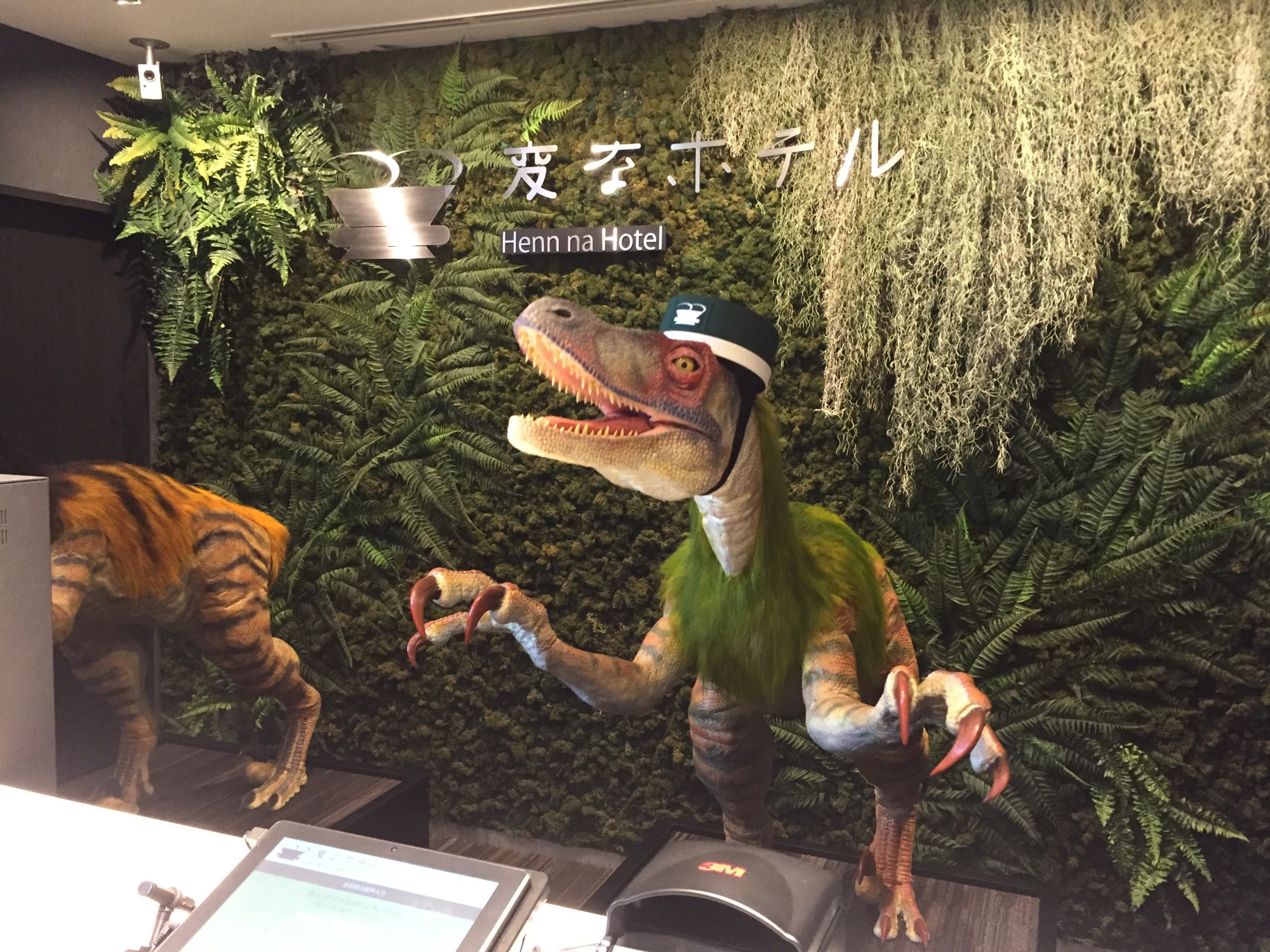 Dinosaur robots serve as receptionists during a media preview for the newly-opened Henn na Hotel in Urayasu, Chiba Prefecture, on Wednesday. | DAISUKE KIKUCHI