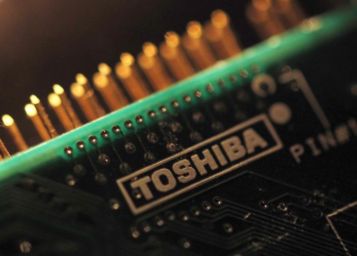 A Toshiba Corp. logo is seen on a printed circuit board. A state-backed consortium is reportedly mulling investing in Toshiba's memory chip business. | REUTERS