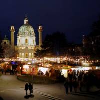 An advent market is seen in front of Karlskirche church in Vienna in December. | REUTERS
