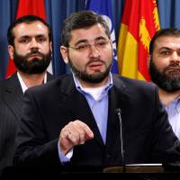 Abdullah Almalki (center), with Muayyed Nureddin (left) and Ahmad El Maati, speaks during a news conference on Parliament Hill in Ottawa in October 2007. | REUTERS