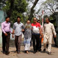 Security personnel bring Shaikh Mohammad Abul Kashem in front of media on Friday in Dhaka after his arrest on Thursday. Bangladesh arrests Islamist militant who urged killing of foreigners