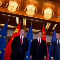 European Commission President Jean-Claude Juncker (left), Chinese President Xi Jinping and European Council President Donald Tusk pose before a meeting at the Diaoyutai State Guesthouse in Beijing in July. | REUTERS