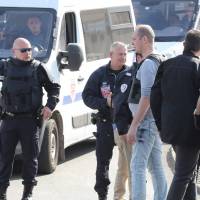 Police stand near their vehicles in the southern French town of Grasse on Thursday following a shooting in the Tocqueville high school. | AFP-JIJI