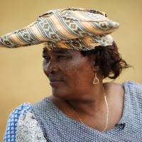 Sarafina Nbaimbaind wears the traditional horned headdress that symbolizes the Herero heritage of cattle herding. | REUTERS