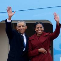 Former U.S. President Barack Obama waves with his wife, Michelle, as they board Special Air Mission 28000, a Boeing 747 that serves as Air Force One, at Joint Base Andrews, Maryland, on Jan. 20. In Obama's final year, U.S. spent $36 million in suits over access to records