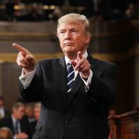 U.S. President Donald Trump reacts after delivering his first address to a joint session of Congress from the floor of the House of Representatives in Washington on Tuesday. | REUTERS