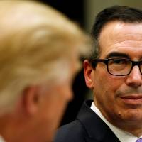 U.S. Treasury Secretary Steve Mnuchin listens as President Donald Trump speaks during a lunch on \"strategic initiatives\" at the White House on Feb. 22. | REUTERS