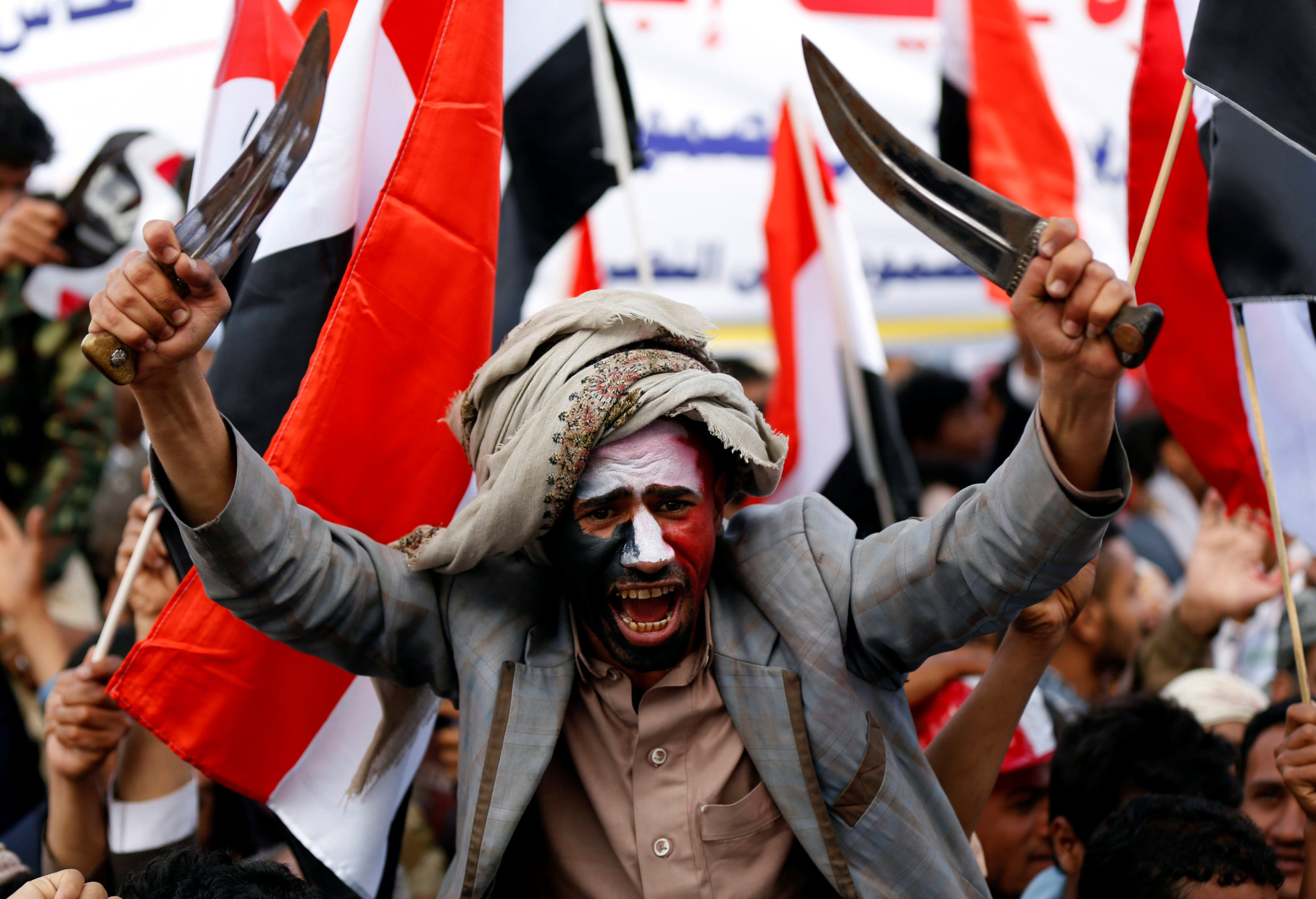 A man waves traditional daggers, or jambiyas, during a mass rally by supporters of the Houthi movement and former Yemeni President Ali Abdullah Saleh in Sanaa on Sunday. | REUTERS