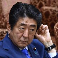 Prime Minister Shinzo Abe awaits questions during an appearance before the Upper House Budget Committee on Friday.  | AFP-JIJI