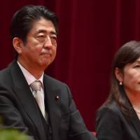 Prime Minister Shinzo Abe and Defense Minister Tomomi Inada attend the graduation ceremony of the National Defense Academy in Yokosuka, Kanagawa Prefecture, on Sunday. | AFP-JIJI