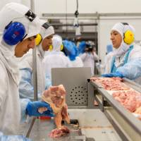 Employees work on a production line at the JBS-Friboi chicken processing plant during an inspection by Brazilian Agriculture Minister Blairo Maggi and technicians of the ministry in Lapa, Brazil, on Tuesday. | AFP-JIJI