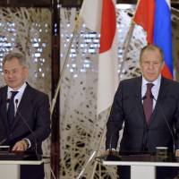 Russian Foreign Minister Sergey Lavrov (right) and Defense Minister Sergei Shoigu attend a joint news conference with Foreign Minister Fumio Kishida and Defense Minister Tomomi Inada after their meeting in Tokyo on Monday. Japan-Russia security talks seen symbolic, may only benefit Moscow