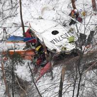 In this photograph taken from a Kyodo News helicopter, a crashed rescue helicopter belonging to the Nagano Prefectural Government can be seen. It went down in a mountainous area in the prefecture with nine people aboard. | KYODO