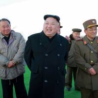 North Korean leader Kim Jong Un laughs after a ballistic missile drill in this undated photo released Tuesday. | KCNA / VIA REUTERS