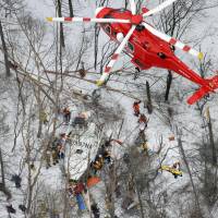 Recovery operations continue Monday after a fire helicopter with nine aboard crashed during a drill Sunday in a mountainous area in Nagano Prefecture. | KYODO