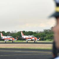 Two TC-90 training planes are lined up at a naval base in Cavite province, south of Manila, on Monday. | KYODO