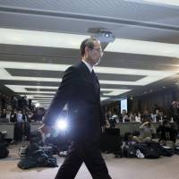 Toshiba Corp. President Satoshi Tsunakawa arrives for a news conference in Tokyo on Tuesday. Toshiba is considering selling a majority stake in its Westinghouse nuclear unit. Shareholders, former employees watch as Toshiba's fortunes fall