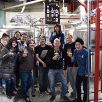 The Kyoto Brewing team poses with collaborators at the brewery on Feb. 4. | SATOKO KAWASAKI