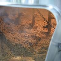 Collaborators helped to remove the spent grain, which local farmers will repurpose as animal feed. | SATOKO KAWASAKI